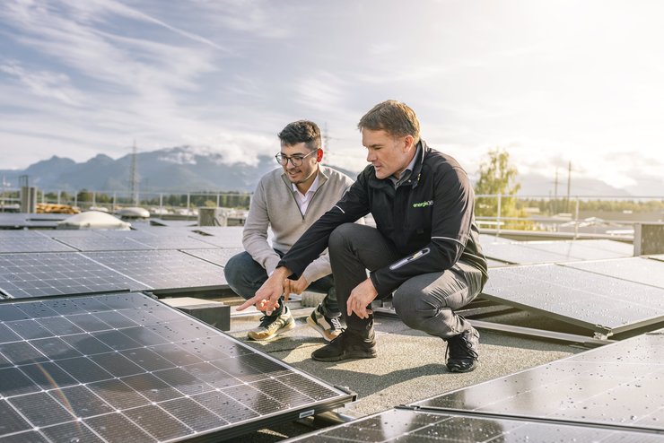 Zwei Photovoltaik-Spezialisten auf dem Dach mit PV-Modulen